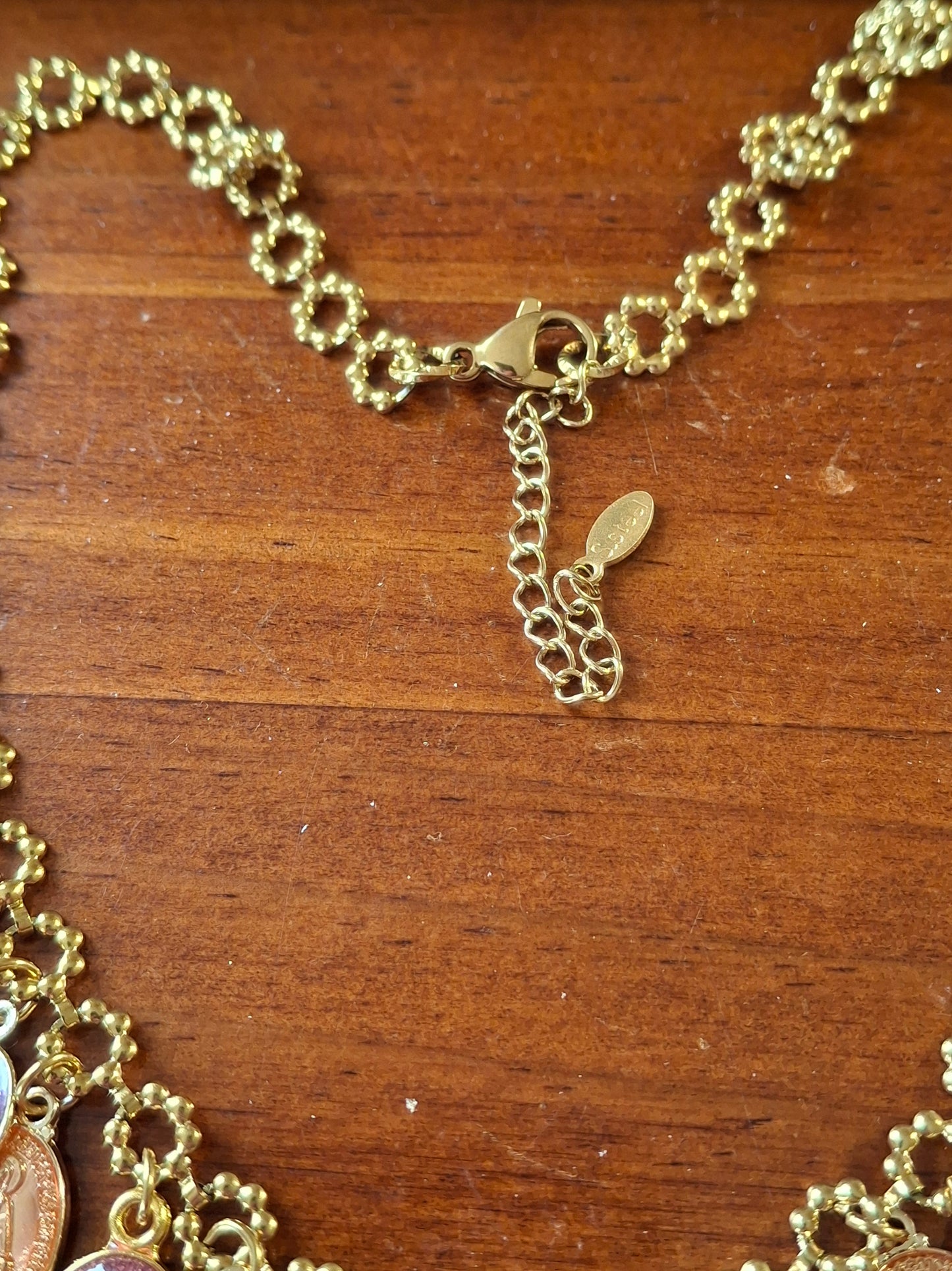 Adjustable gold-tone stainless steel chain necklace with flower motif and Madonna charms