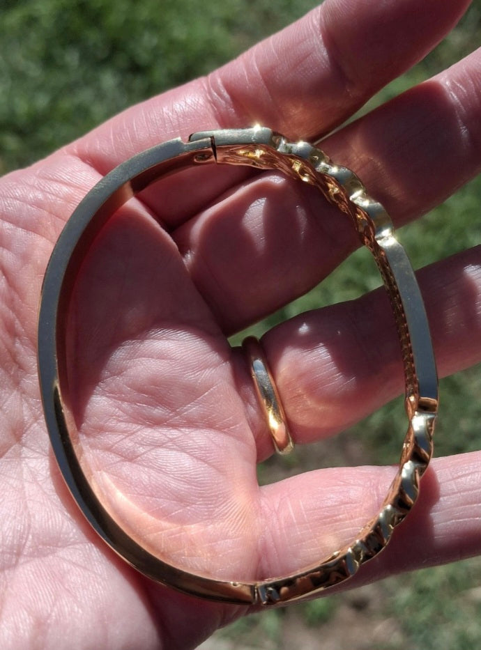 Rigid bracelet with zirconium-set charm, made of stainless steel 316.