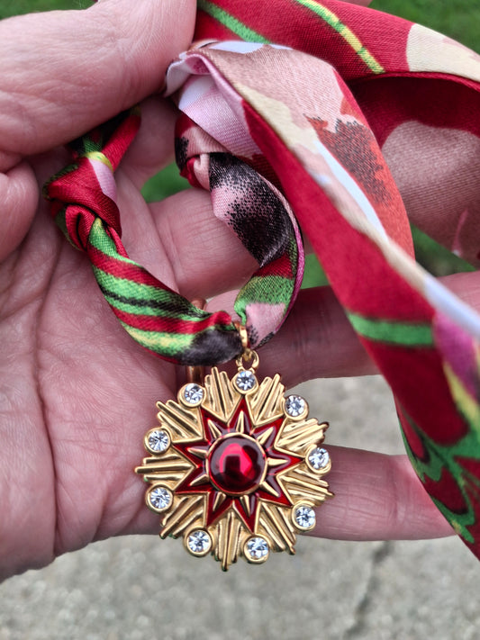 Stainless steel 316 polished scarf necklace with sun pendant.